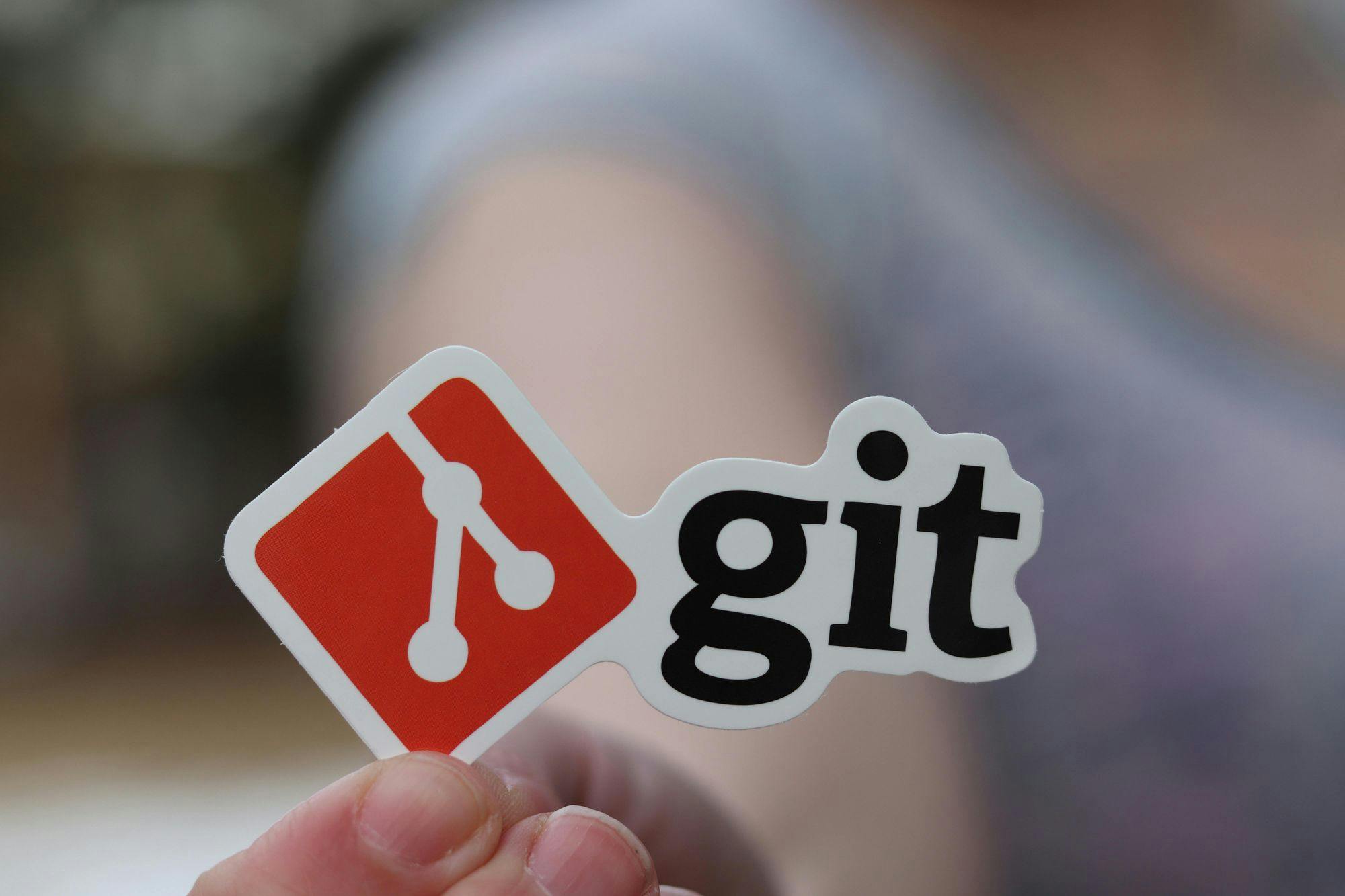 Person holding a Git sticker.